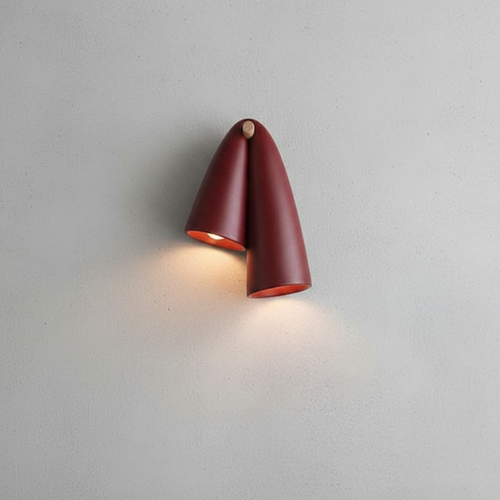 Burgundy ceramic wall sconce with glossy dual-cone ceramic body and natural wood-toned mount